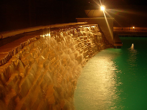 Swimming pool with cascading waterfall