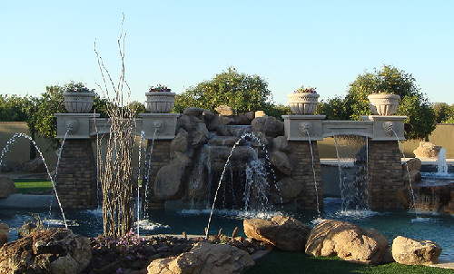 Shotcrete swimming pool with deck jets, scuppers and grotto