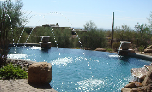 Shotcrete swimming pool with negative edge and deck jets